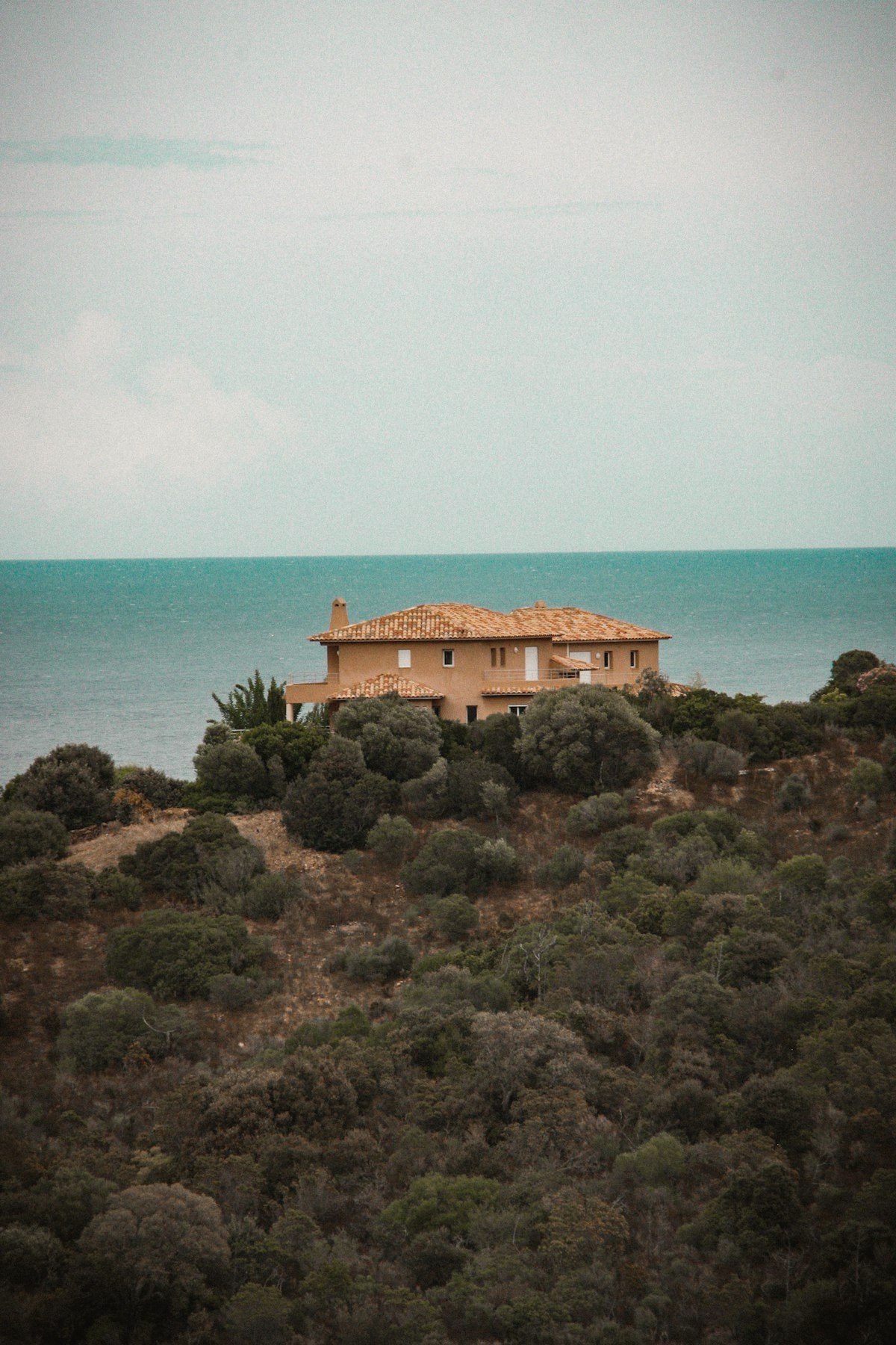 A stone house on the hill in wind-cleared light